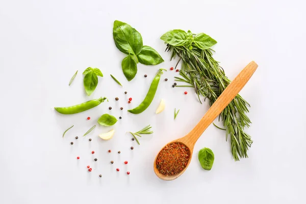 Fresh herbs with vegetables and spices on light background — Stock Photo, Image