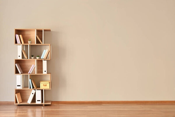 Modern shelf unit near light wall
