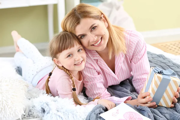 Little girl greeting her mother at home Stock Image