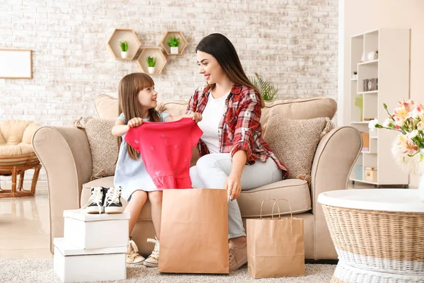 Portrait of happy mother and daughter with shopping bags at home — Stock Photo, Image