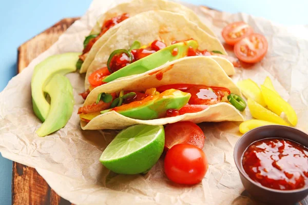 Tasty fresh tacos and sauce on board, closeup — Stock Photo, Image