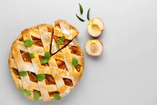 Tasty peach pie on light background — Stock Photo, Image