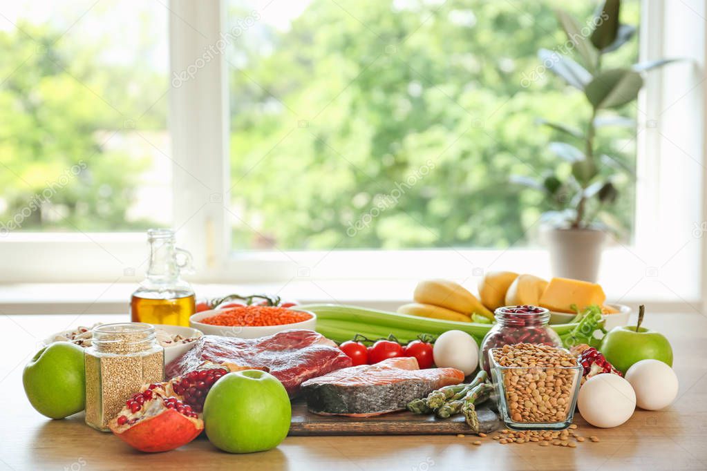 Different healthy food on table in kitchen