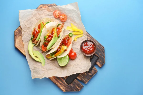 Tablero con sabrosos tacos frescos y salsa sobre fondo de color — Foto de Stock