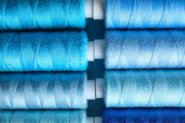 Багато кольорів швейних ниток як фон — стокове фото
