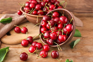 Ahşap arka plan üzerinde tatlı olgun kiraz ile Bowls