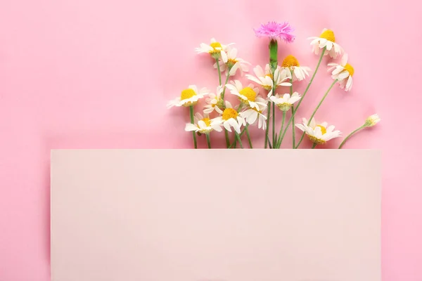 Empty card with fresh wild flowers on color background — Stock Photo, Image