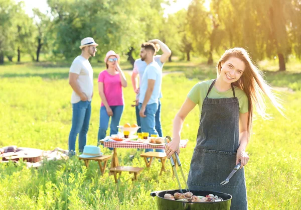 Woman cooking tasty food on barbecue grill outdoors — Stock Photo, Image