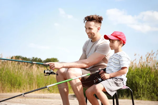 Father and son fishing together on river — Stock Photo, Image