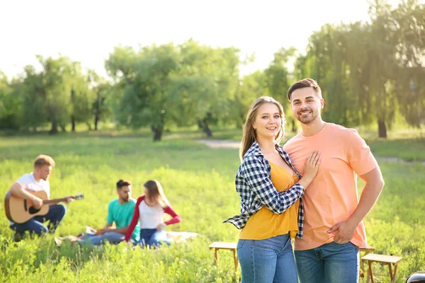 Young couple at barbecue party outdoors — Stock Photo, Image