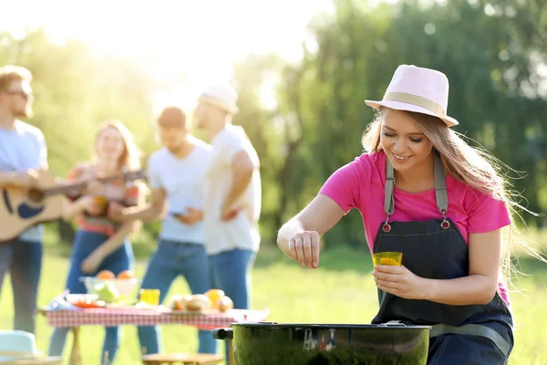 Woman cooking tasty food on barbecue grill at party outdoors — Stock Photo, Image