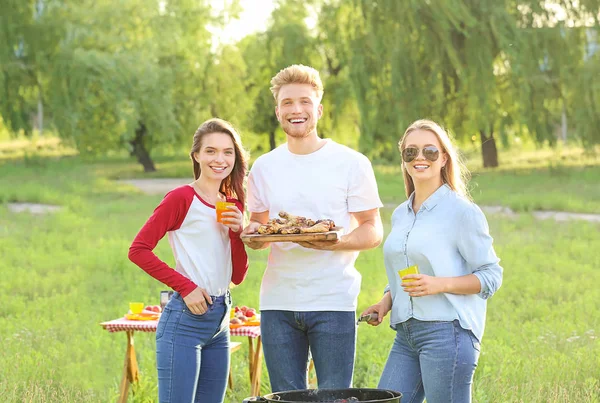 Friends at barbecue party outdoors — Stock Photo, Image