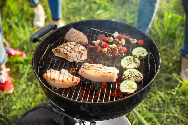 Cooking of tasty food on barbecue grill outdoors — Stock Photo, Image