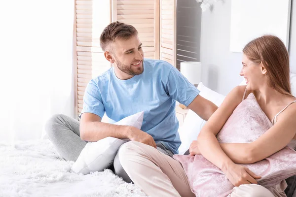 Portrait of happy young couple in bedroom — Stock Photo, Image