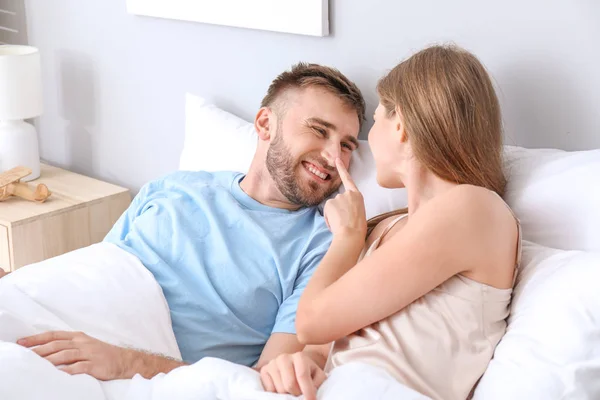 Portret van gelukkig jong stel in slaapkamer — Stockfoto