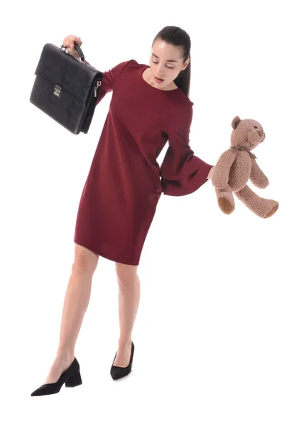 Balansera affärskvinna med portfölj och leksak på vit bakgrund — Stockfoto