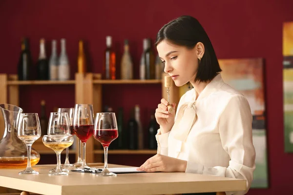 Young female sommelier working in wine cellar — Stock Photo, Image