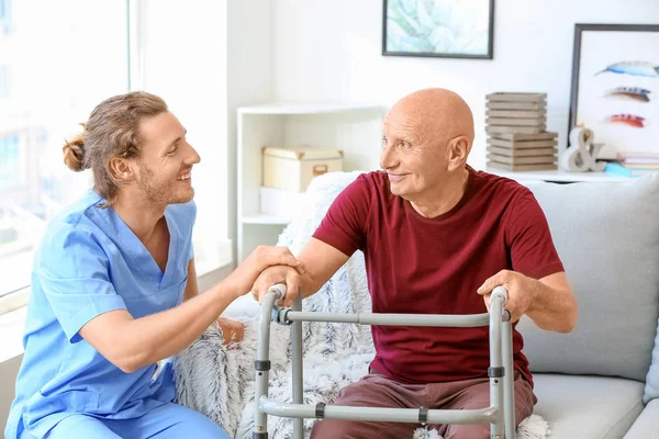 Elderly man with caregiver in nursing home — Stock Photo, Image