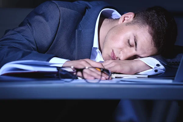 Yorgun işadamı akşam geç saatlerde ofis masasında uyuyor — Stok fotoğraf
