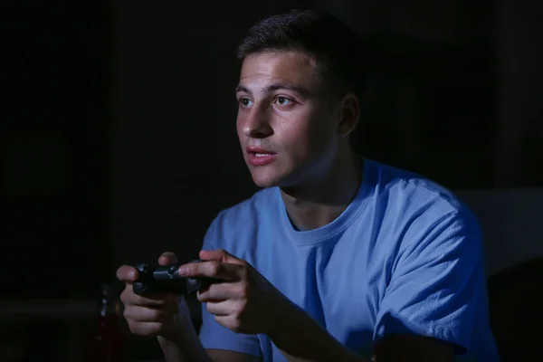 Young man playing video game late in evening — Stock Photo, Image