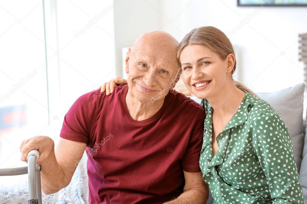 Young woman visiting her elderly father in nursing home