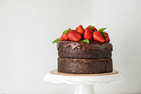 Tasty chocolate cake with strawberry on white background — Stock Photo, Image