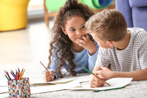 Happy adopted children drawing pictures in their new home — Stock Photo, Image