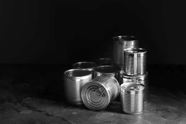 Tin cans with food on dark background — Stock Photo, Image