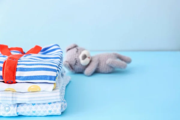 Stack of baby clothes on color background — Stock Photo, Image