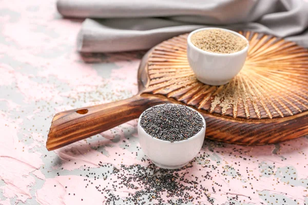 Bowls with different poppy seeds on color background — Stock Photo, Image