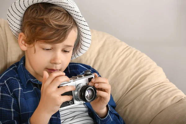 Cute little photographer with professional camera at home — Stock Photo, Image