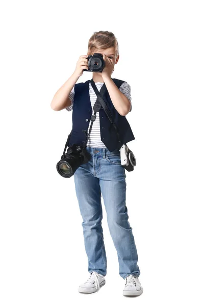 Söt liten fotograf med professionella kameror på vit bakgrund — Stockfoto