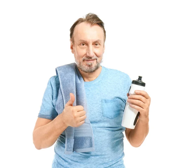 Retrato de homem maduro bonito com garrafa de água mostrando gesto polegar-up no fundo branco — Fotografia de Stock
