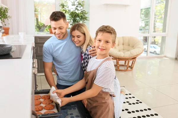 Happy family baking tasty cookies at home — Stock Photo, Image