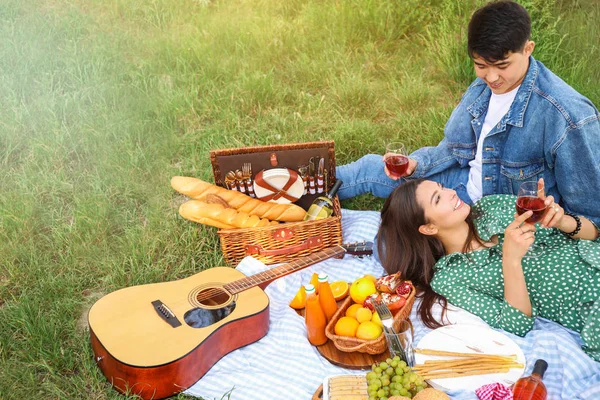 Gelukkig jong stel picknicken in park — Stockfoto