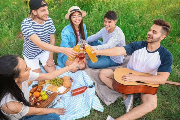 Happy friends on picnic in park