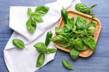 Renkli ahşap arka plan taze fesleğen ve biber ile Tabak