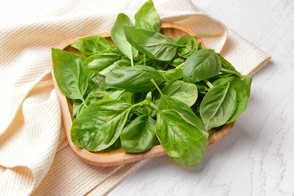 Plate with fresh basil on white table — Stock Photo, Image