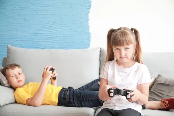 Little children with addiction to video games resting at home