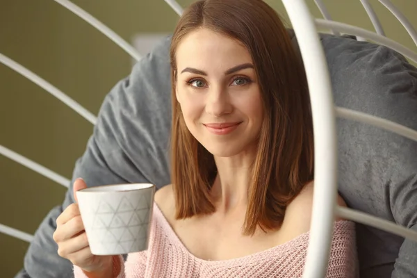Beautiful young woman drinking tea at home — Stock Photo, Image