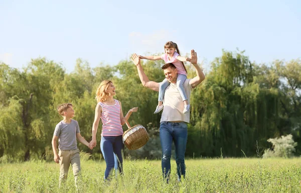 Familia feliz caminando en el parque en el día de verano — Foto de Stock