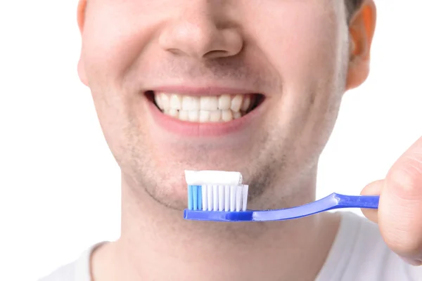 Man with toothbrush on white background, closeup. Concept of dental hygiene — Stock Photo, Image