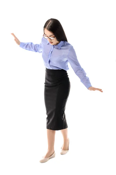Balancing young businesswoman on white background — Stock Photo, Image