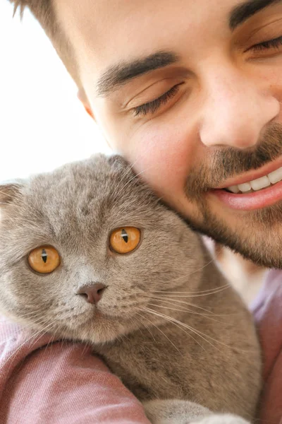 Young man with cute funny cat, closeup — Stock Photo, Image