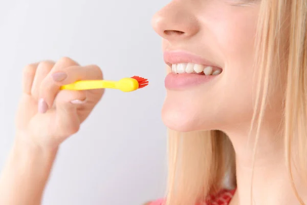Woman with toothbrush on light background, closeup. Concept of dental hygiene — Stock Photo, Image