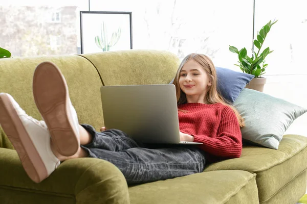 Cute teenage girl with laptop at home — Stock Photo, Image