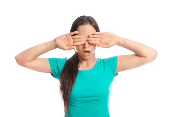 Young woman covering her eyes on white background — Stock Photo, Image