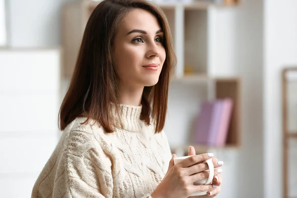 Beautiful young woman drinking tea at home — Stock Photo, Image