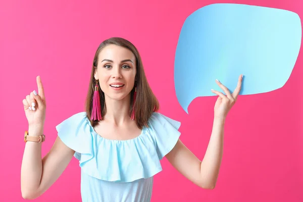 Beautiful young woman with blank speech bubble on color background — Stock Photo, Image