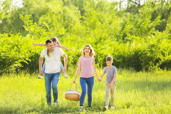 Happy family walking in park on summer day — Stock Photo, Image